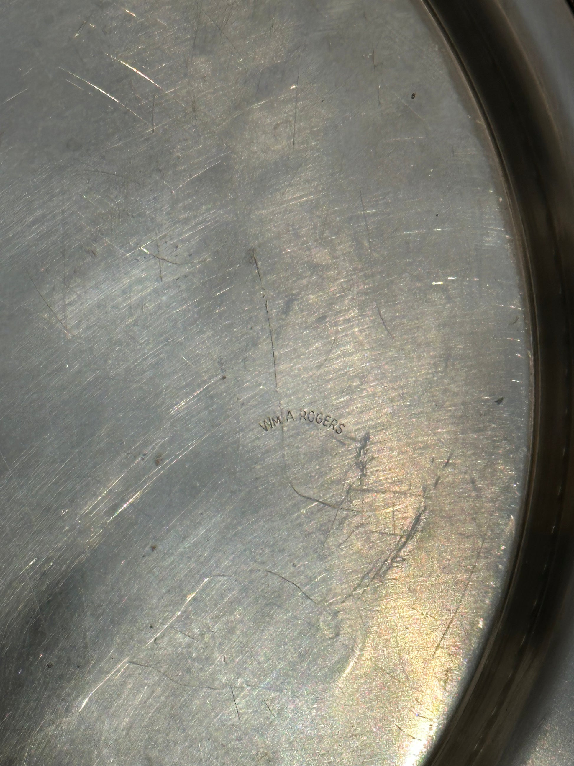 Close-up of 'Wm. A. Rogers' maker's mark engraved on back of silverplate tray