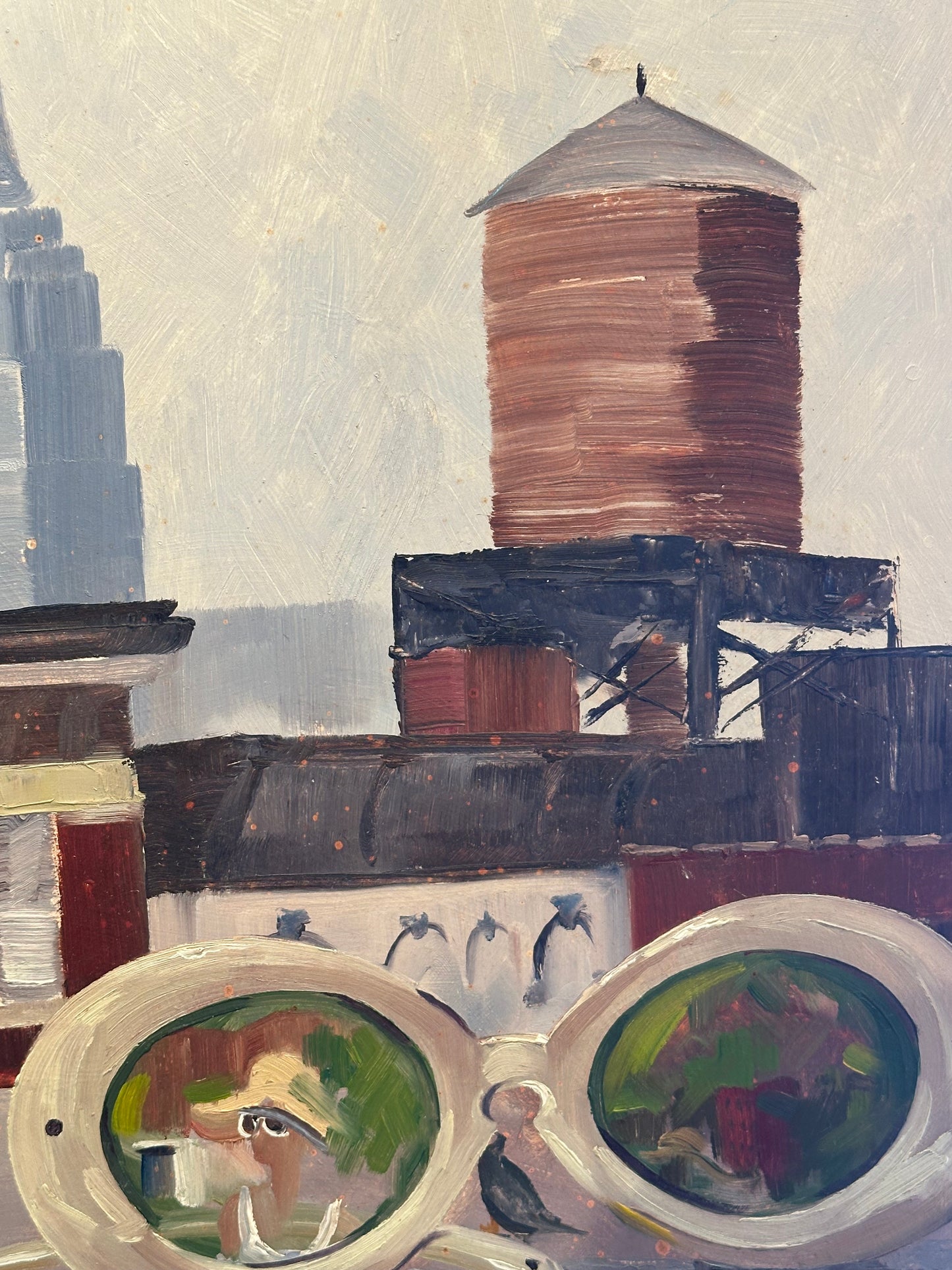 Detail of NYC skyline painting: rooftop water tower and skyscraper with white-rimmed sunglasses in the foreground.