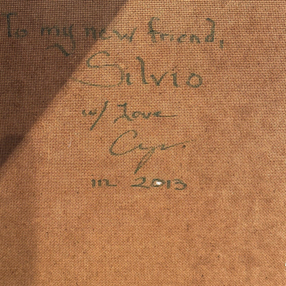 Close-up of green handwritten inscription on the reverse: "To my new friend, Silvio w/ Love," dated 2013.