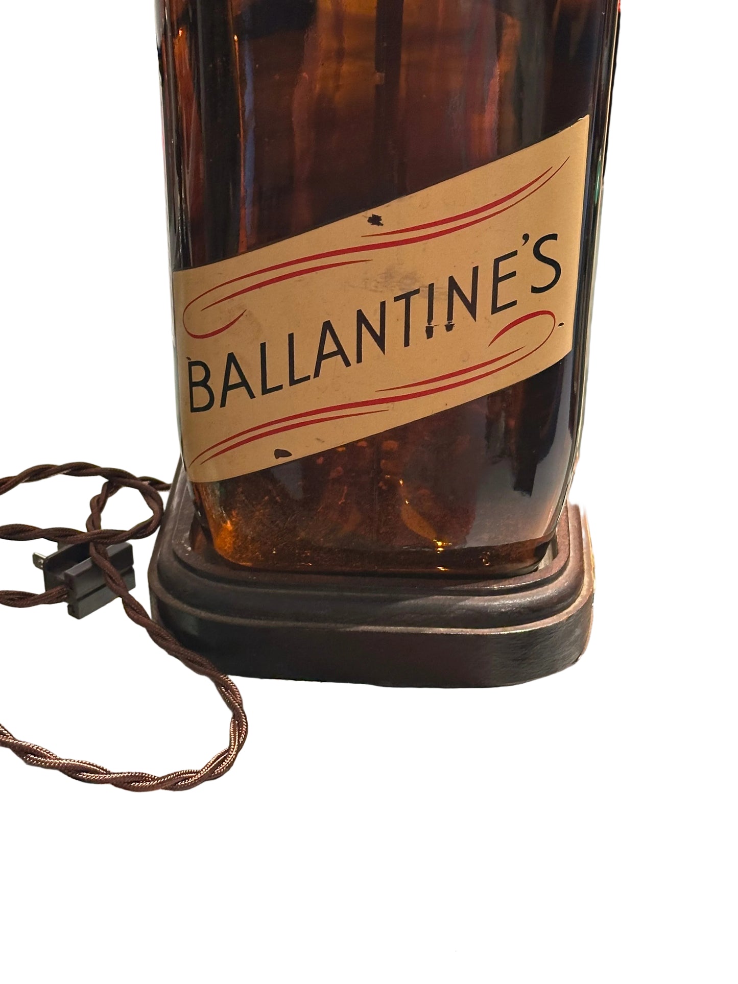 Lower bottle showing diagonal 'BALLANTINE'S' banner label, wood base and braided cord