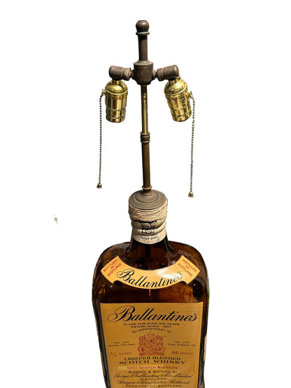Close-up of the lamp's twin brass sockets, pull chains and cord-wrapped bottle neck