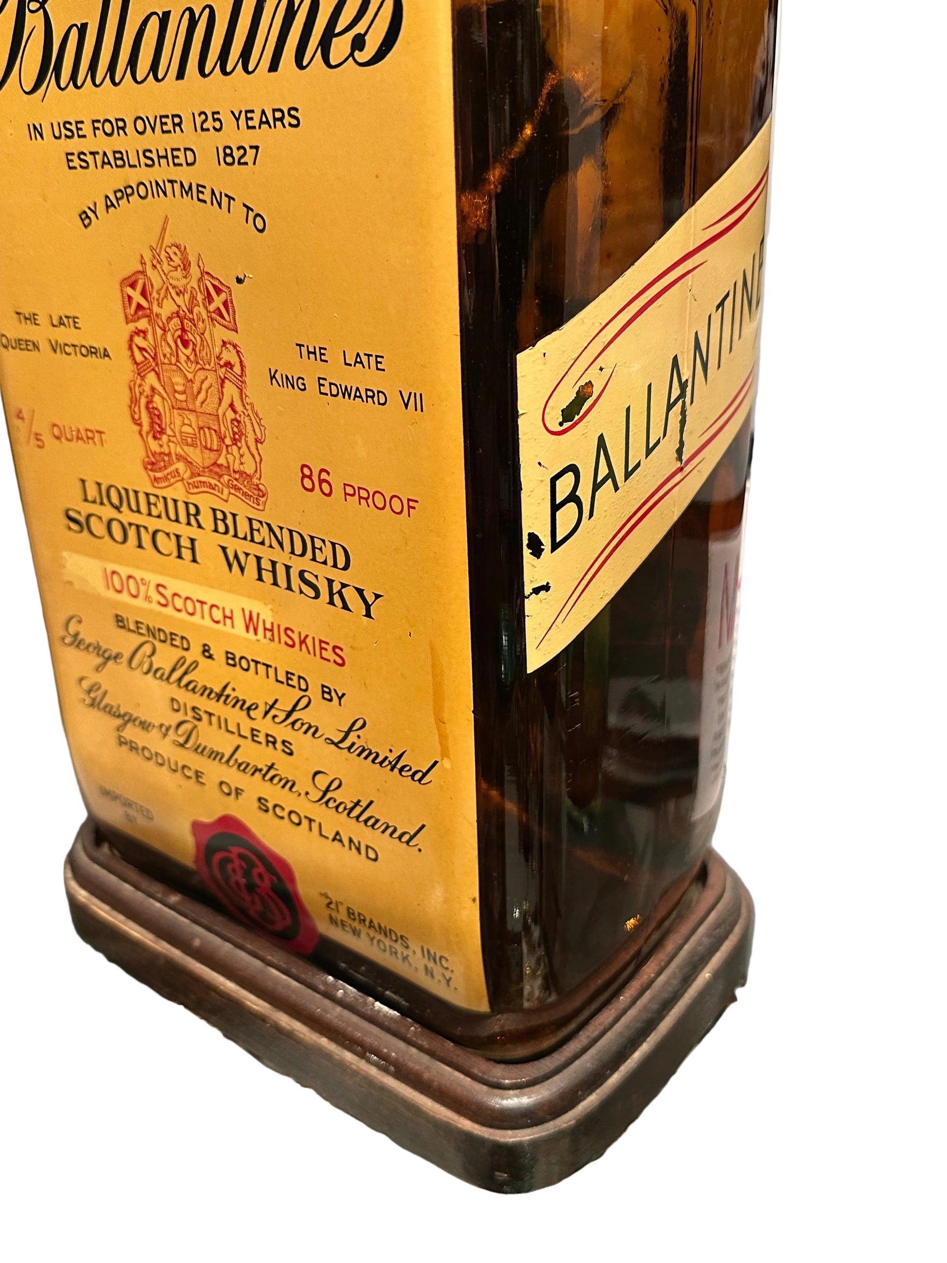 Bottle base and label detail with '21 Brands' seal and coiled electrical cord