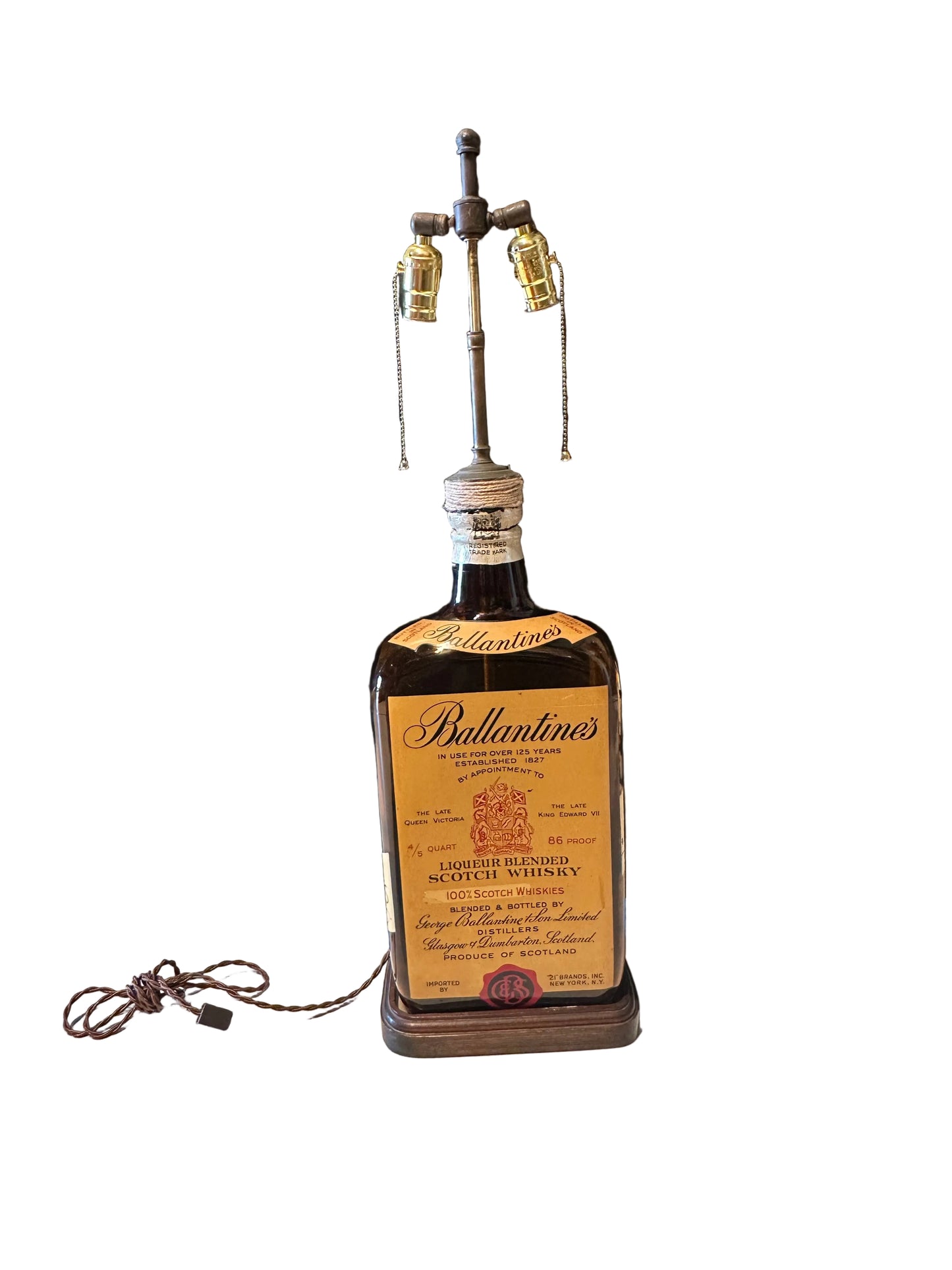 Full Ballantine's bottle lamp, front view with coiled cord and turned wood base