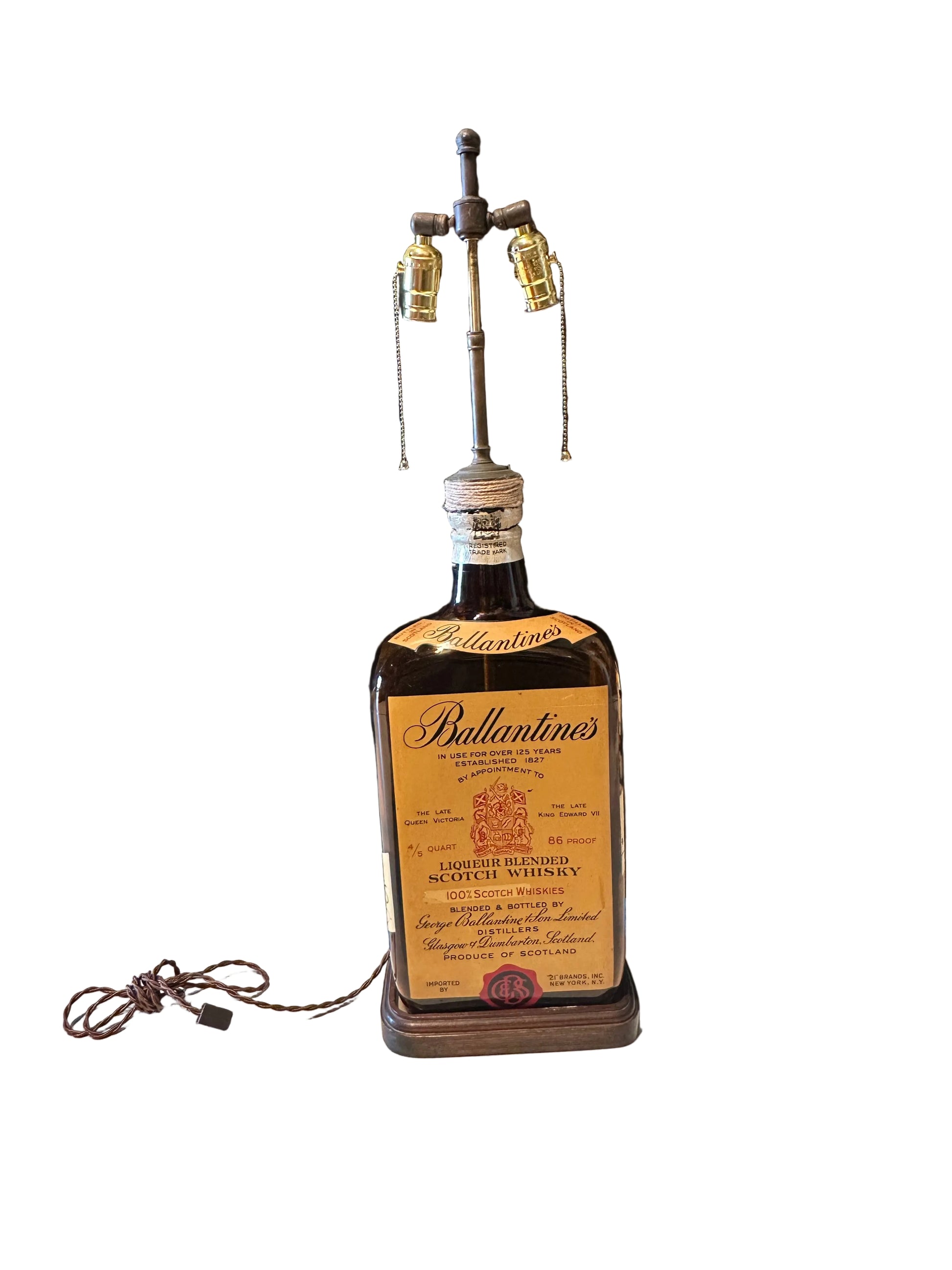 Full Ballantine's bottle lamp, front view with coiled cord and turned wood base