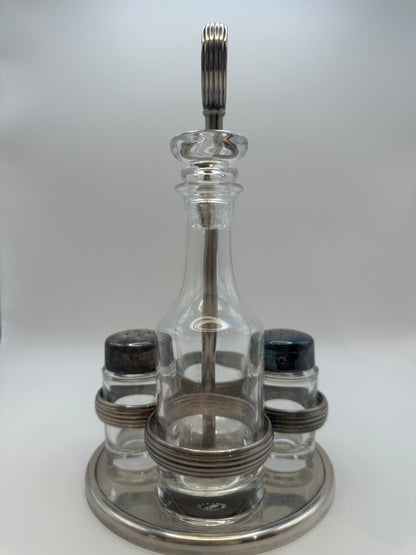 MCM silverplate cruet set, front view of glass cruet and salt and pepper shakers in stand.