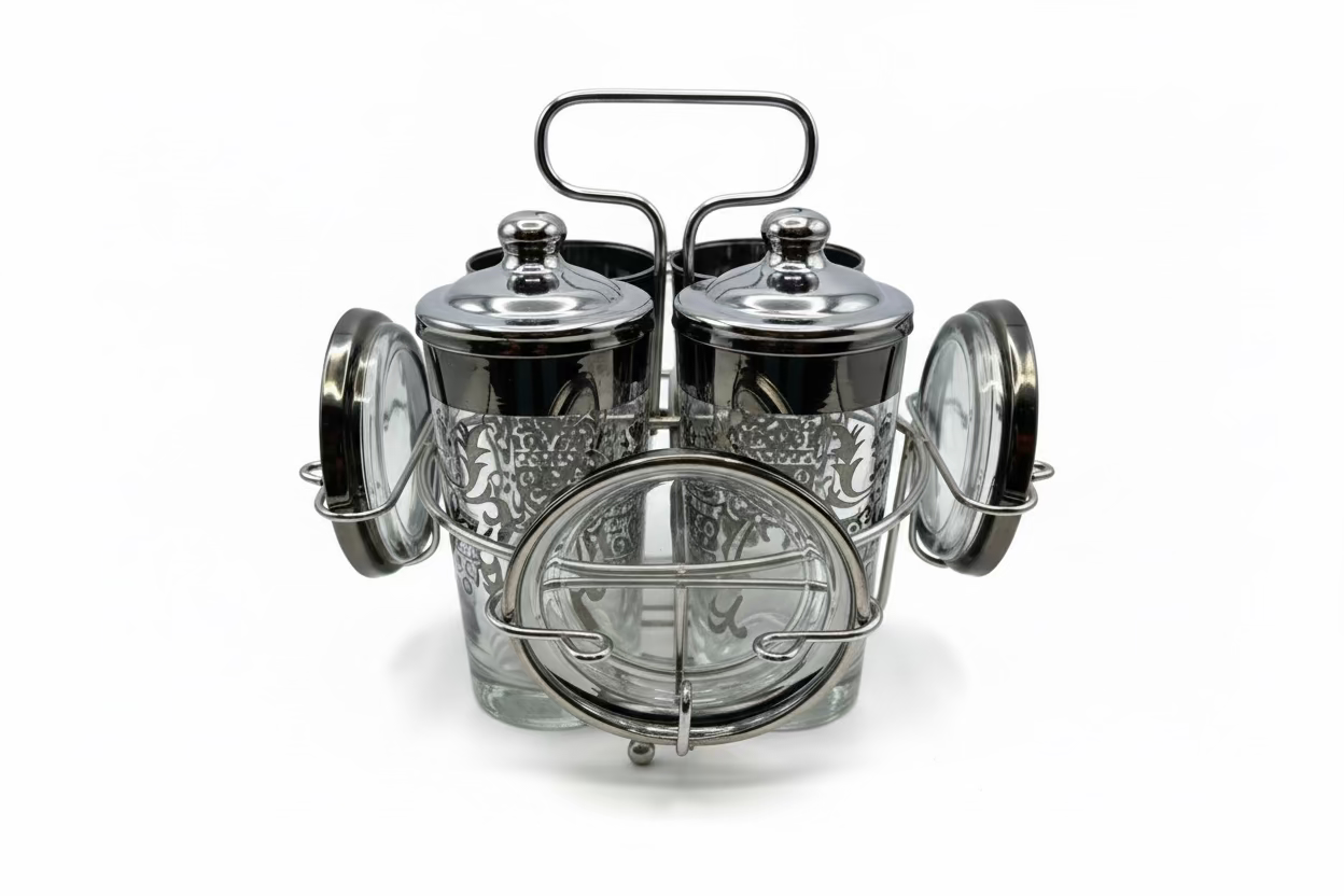 Vintage MCM Kimiko barware set: four silver-fade highball glasses and coasters in a chrome caddy.