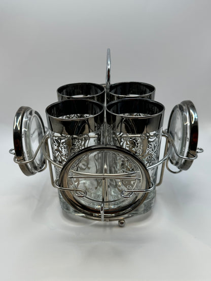 MCM Kimiko barware set of four glasses and coasters in chrome caddy, angled view.