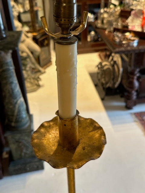 Detail of the gilt lamp's scalloped drip pan and faux-candle column with brass socket