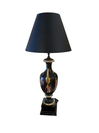Full view of the black Neoclassical lamp, painted figures, black shade, square plinth