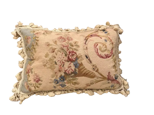 Vintage needlepoint pillow, front: floral trumpet basket with scroll on beige ground, cotton tassel fringe