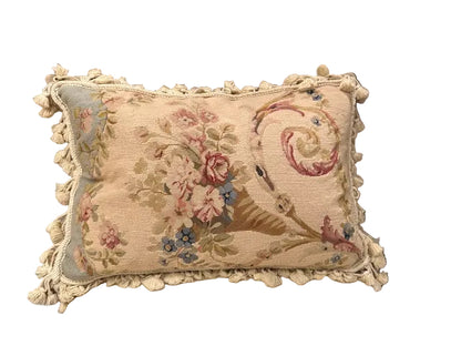 Vintage needlepoint pillow, front: floral trumpet basket with scroll on beige ground, cotton tassel fringe