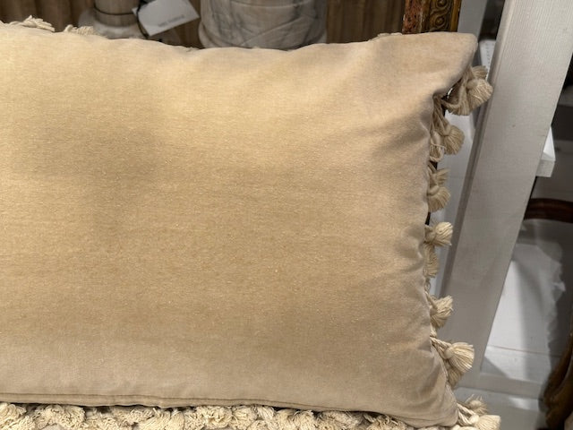 Back of needlepoint pillow in plain beige velvet with tassel fringe