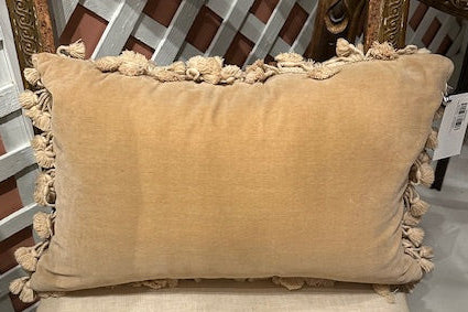 Back of needlepoint pillow in plain tan velvet with cotton tassel fringe