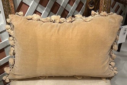 Back of needlepoint pillow in plain tan velvet with cotton tassel fringe