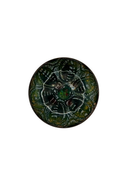 Top view of Doris Hall enamel dish, green and black abstract pattern around a central cabochon