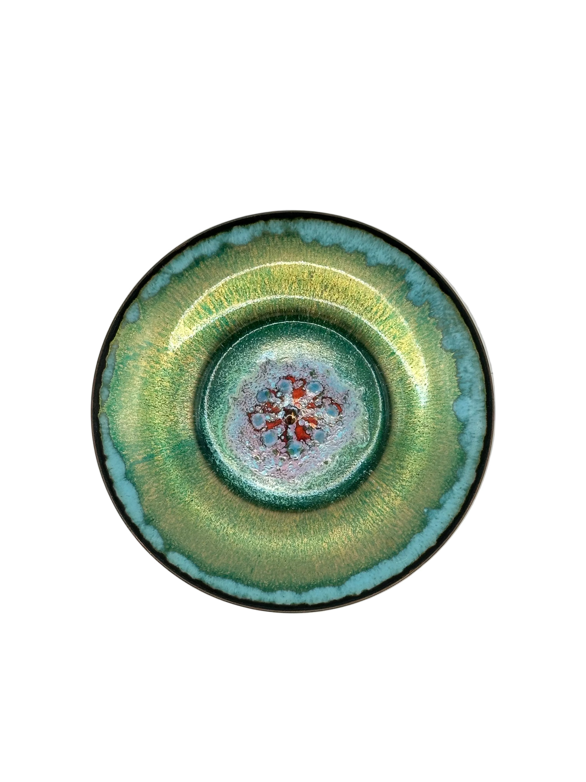 Doris Hall petite green enamel dish, top view of red and turquoise starburst floral center