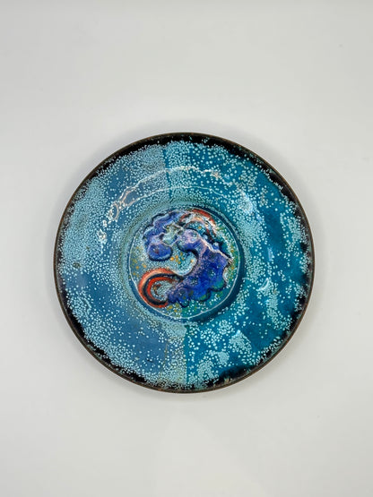 Doris Hall enamel-on-copper dish, blue speckled glaze with cobalt and red swirl center, top view