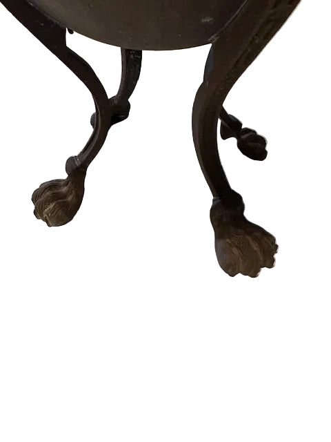 Close-up of bronze jardiniere's tripod legs ending in claw feet