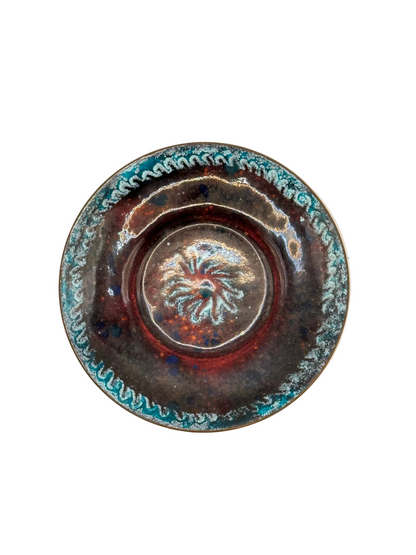 Doris Hall enamel-on-copper dish, abstract deep-red and brown glaze with mottled turquoise rim, top view