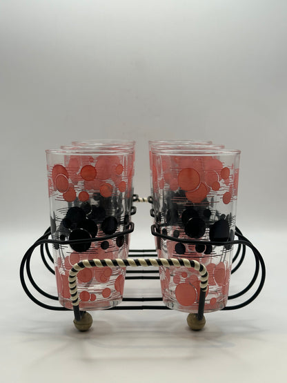 Close-up of two atomic polka-dot tumblers in the wire caddy with striped wrapped handle