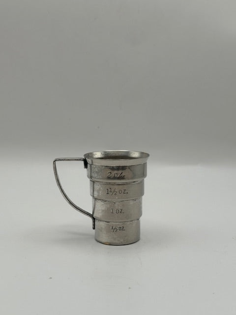 Vintage Art Deco silver-plate jigger, three-quarter view of tiered body with faint ounce markings