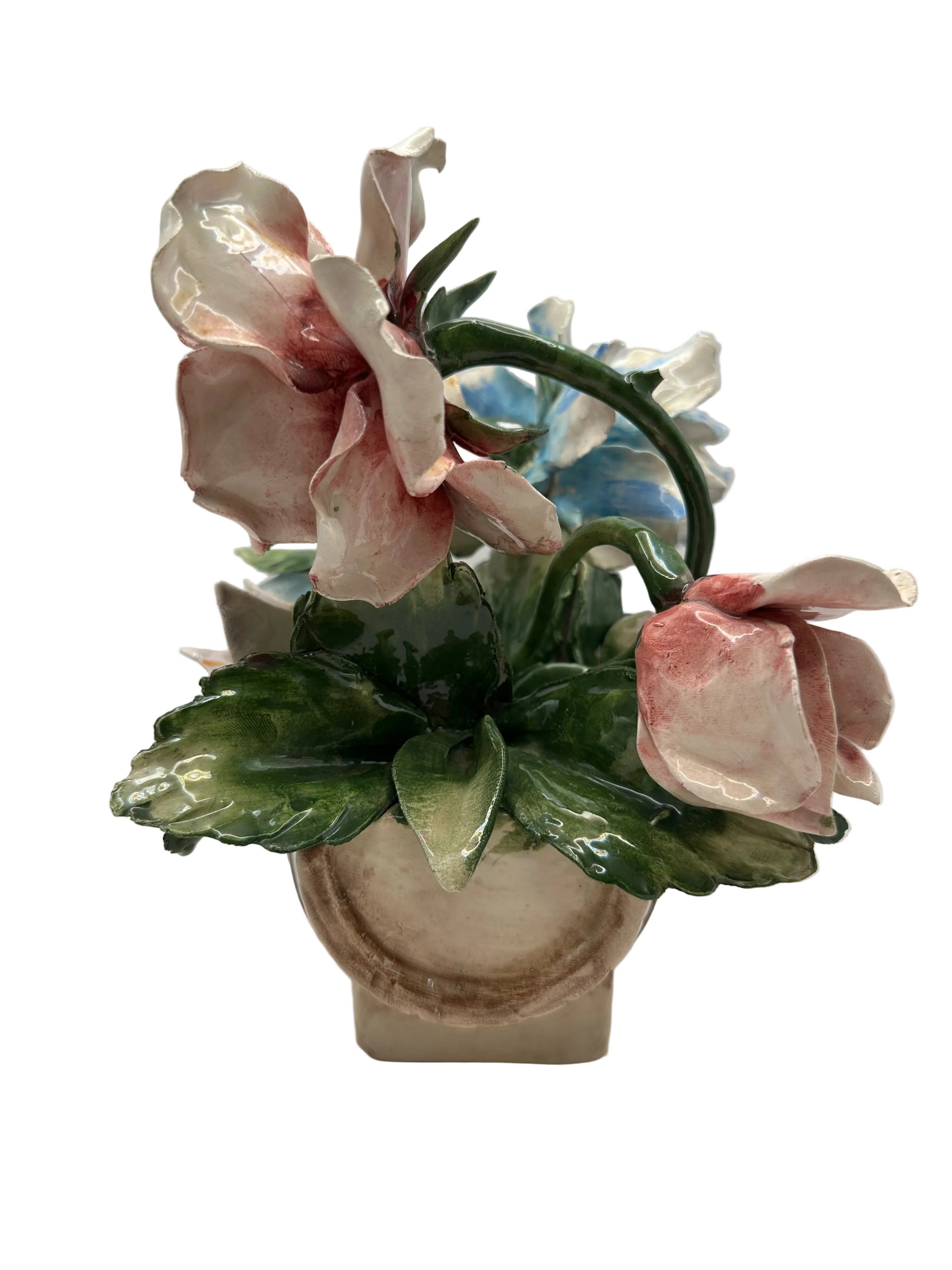 Back view of the porcelain flower bouquet showing rose buds and green leaves on the base