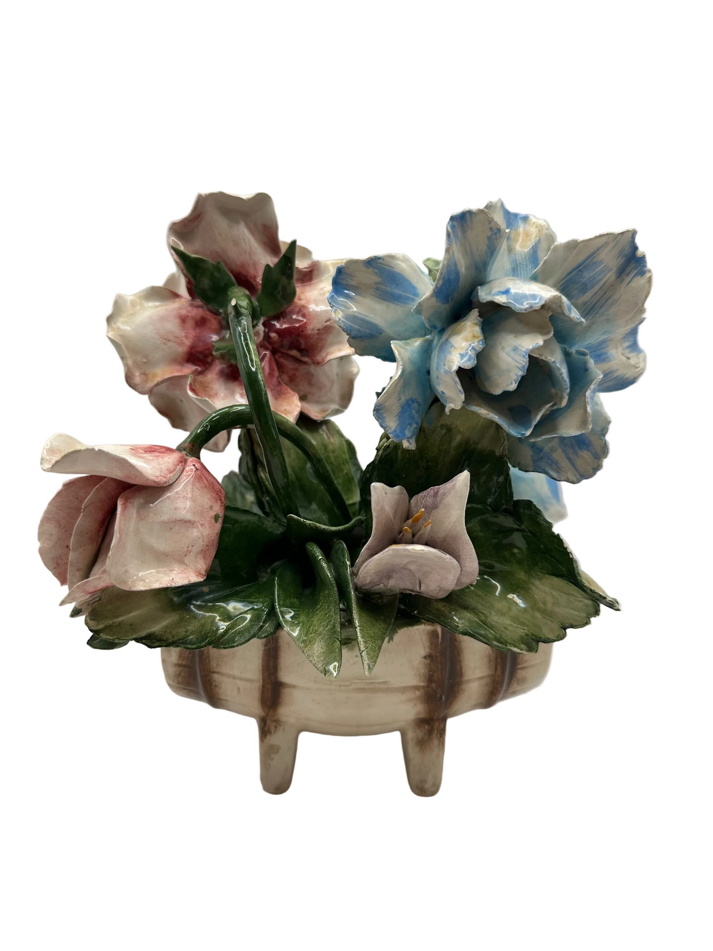 Porcelain flower arrangement viewed from another angle with pink and blue ruffled blooms