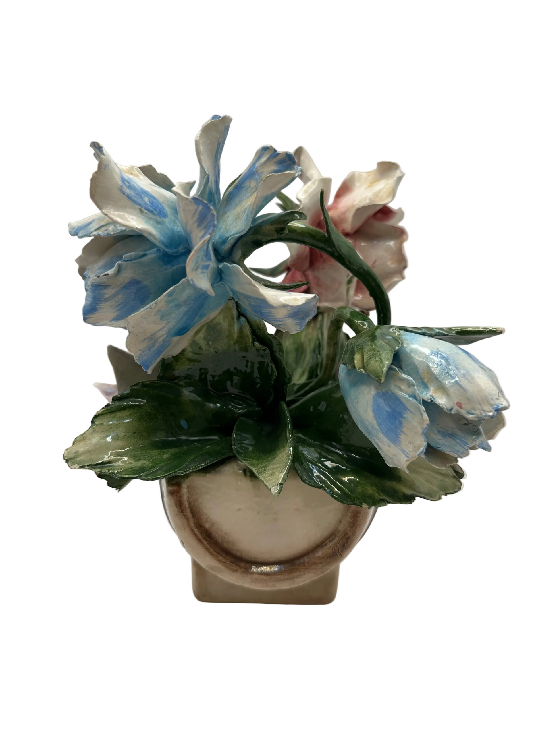 Side view of the porcelain flower arrangement showing blue flowers and the footed base