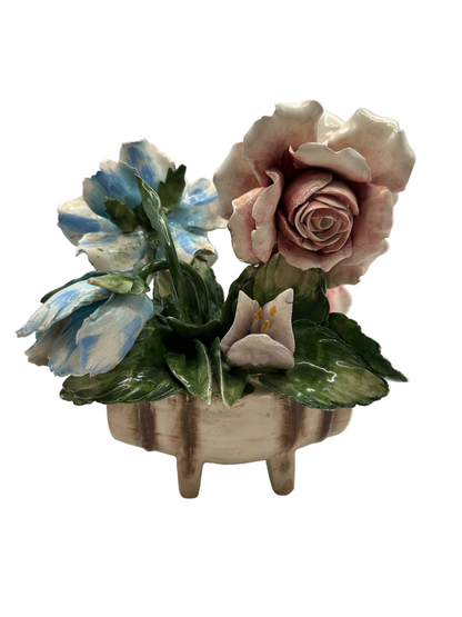 Capodimonte porcelain flower arrangement with a pink rose and blue blossom in a footed bowl