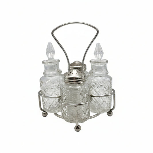 Vintage 4-piece cut-glass cruet set with pointed stoppers and a shaker in a footed silverplate stand.