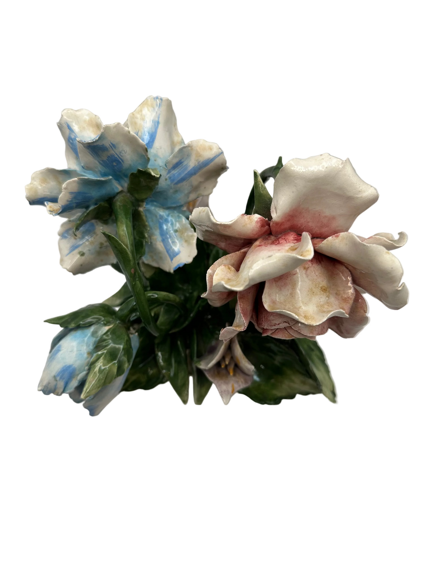 Top close-up of the porcelain blossoms, a blue-streaked flower beside a pink-tinged rose
