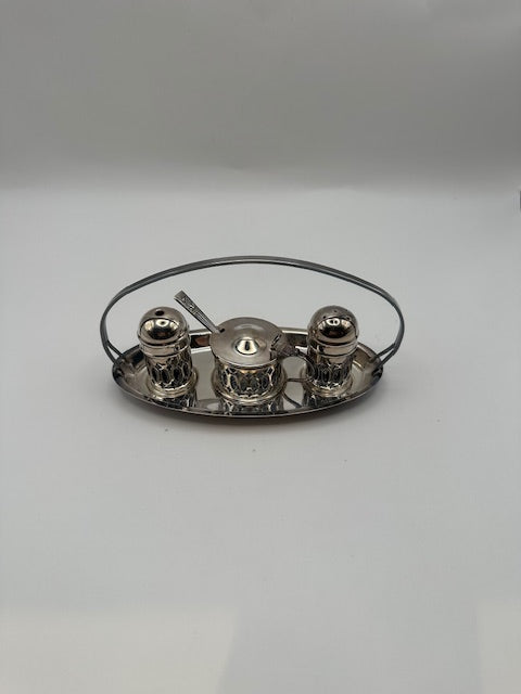 Silverplate cruet set on handled oval stand, side view