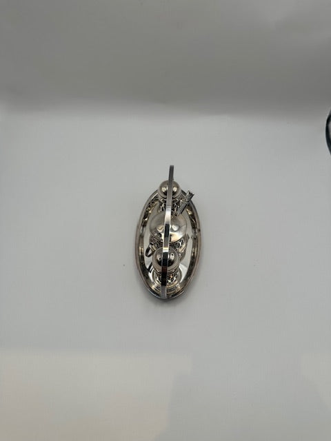Top-down view of silverplate cruet set in its oval carrying stand