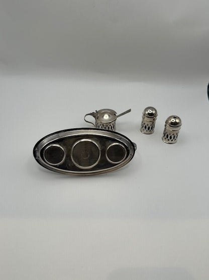 Disassembled cruet set: oval tray, mustard pot and two shakers