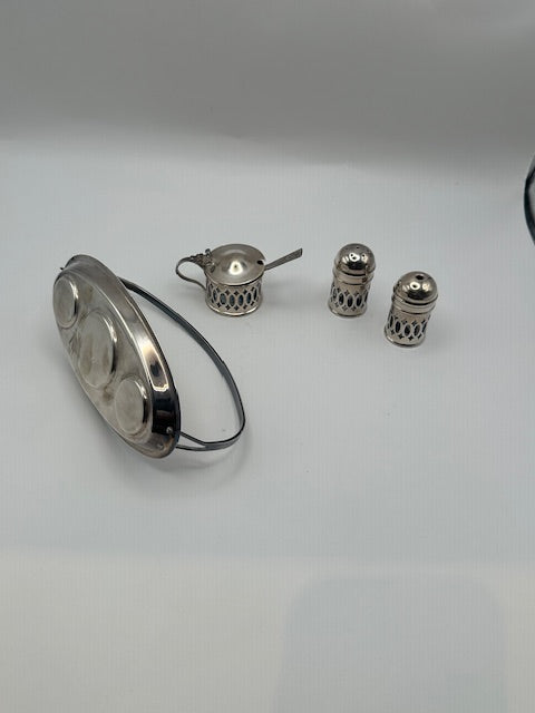 Cruet pieces arranged beside the empty pierced oval stand