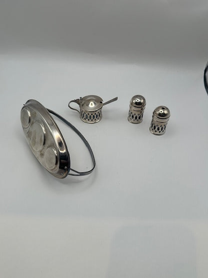 Cruet pieces arranged beside the empty pierced oval stand
