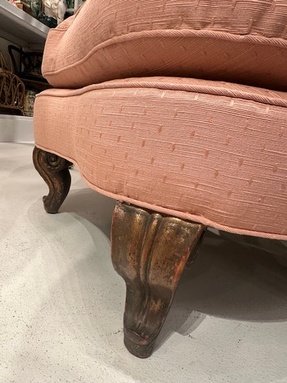 Antique pink coral boudoir chair, detail of the worn giltwood carved leg and upholstered skirt