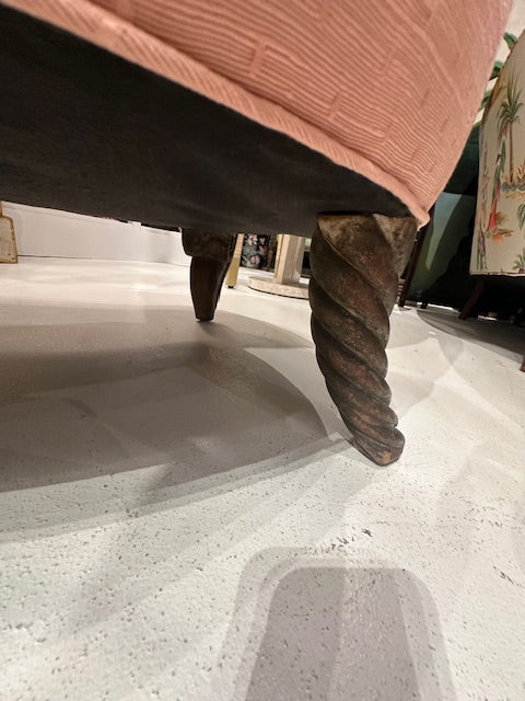 Antique pink coral boudoir chair, low-angle view of the barley-twist wood front leg