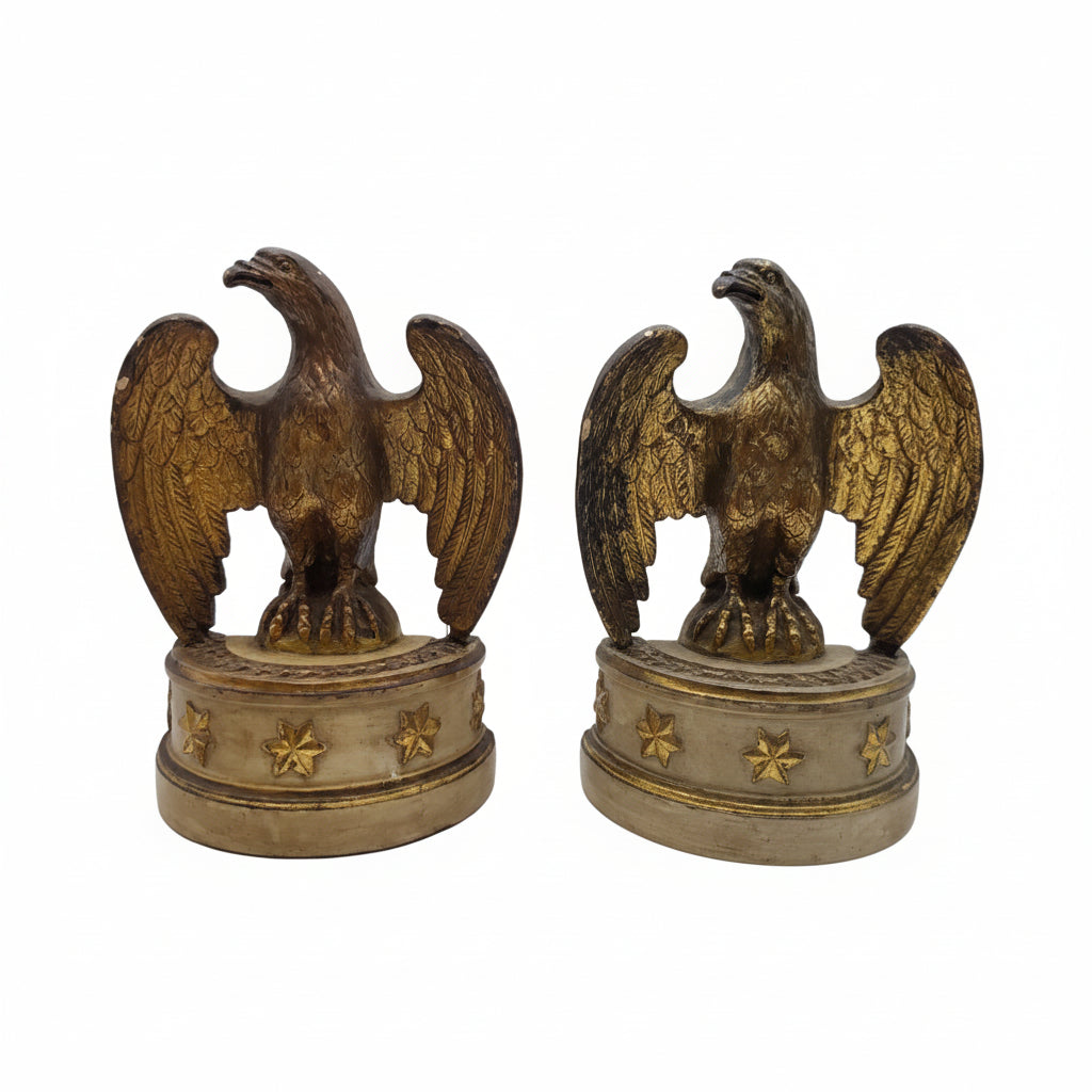 Pair of vintage Borghese gilt and cream eagles with outspread wings perched on round star-studded pedestal bases