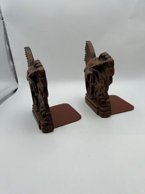 Carved wood sailfish bookends viewed from behind showing serrated dorsal fins