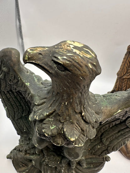 Close-up of an eagle bookend's head, beak and feathered wings with worn finish
