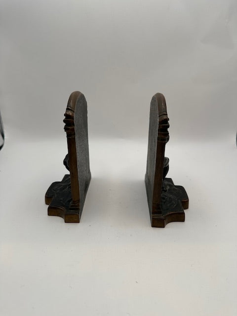 Side profile of the bronze Thinker bookends showing their angled support backs