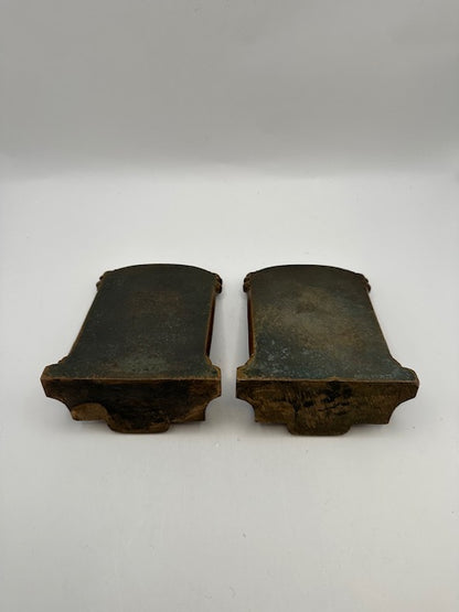 Underside of the bronze Thinker bookends showing aged metal bases