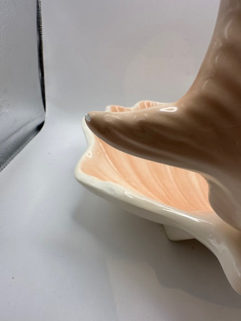 Side view of the peach shell serving dish showing the fish bowl's fluted tail
