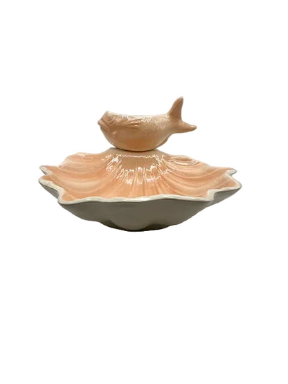 Peach fish-and-shell ceramic serving piece viewed from the front at table level
