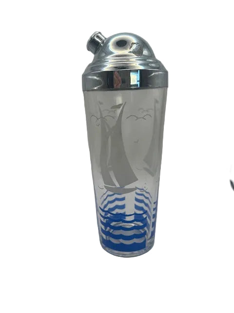 Sailboat cocktail shaker, front view of frosted glass with sailboat, gulls and blue waves