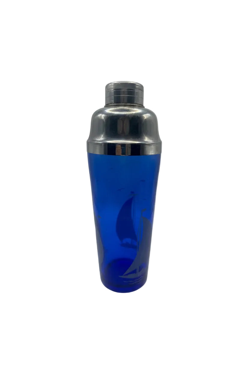 Vintage large cobalt blue glass cocktail shaker with sailboat design and chrome top, front view