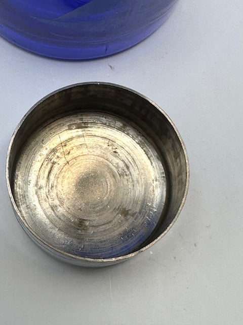 Chrome cup cap of the cobalt sailboat shaker set beside the blue glass body, interior view