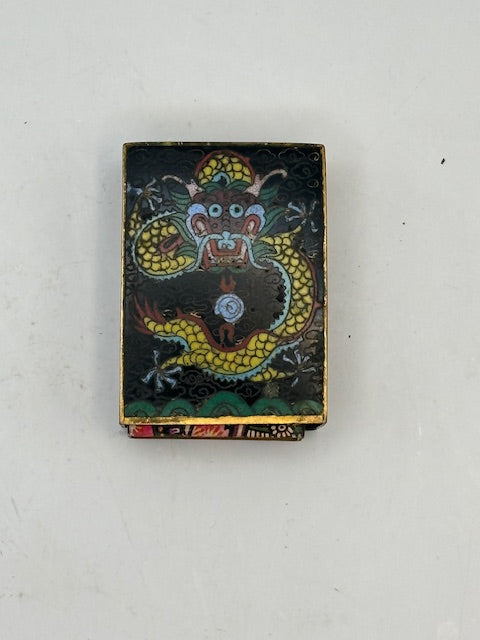 Angled top view of the black cloisonne cover showing the dragon's blue-maned head and gold body