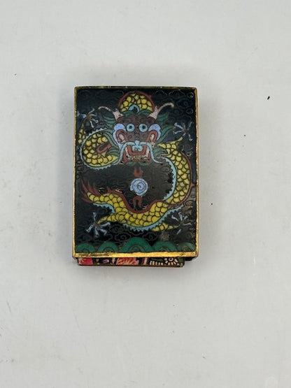 Angled top view of the black cloisonne cover showing the dragon's blue-maned head and gold body